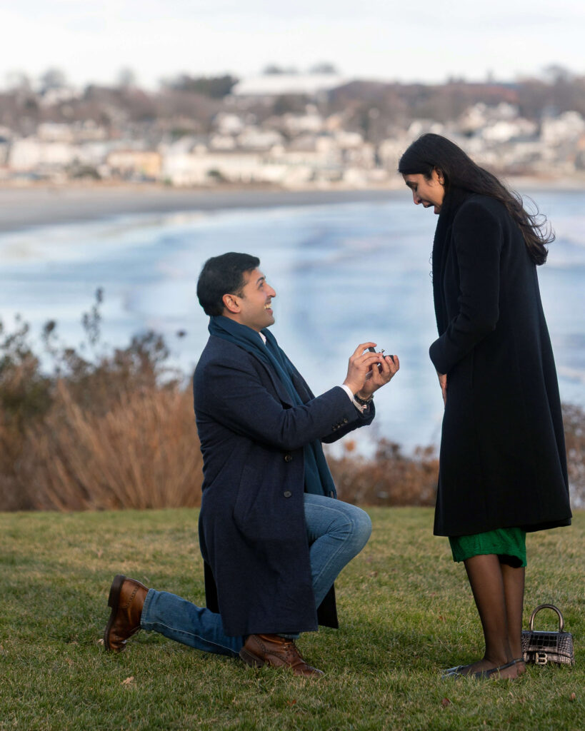 Groom proposing during a Newport Rhode Island surprise engagement at The Chanler